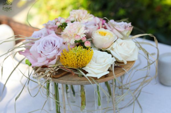 Modern wedding and event table decoration with pastel roses (lavender purple, pink, light yellow, rose, English rose, carnation, leucospermum)