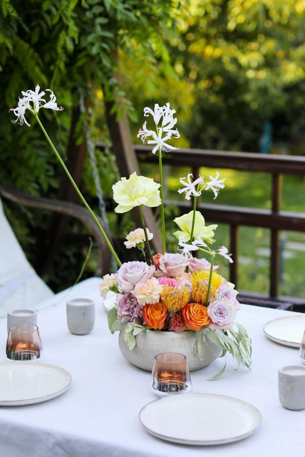 Modern floating table decoration for weddings and events (rose, English rose, leucospermum, carnation, yellow, orange, lavender, pink)