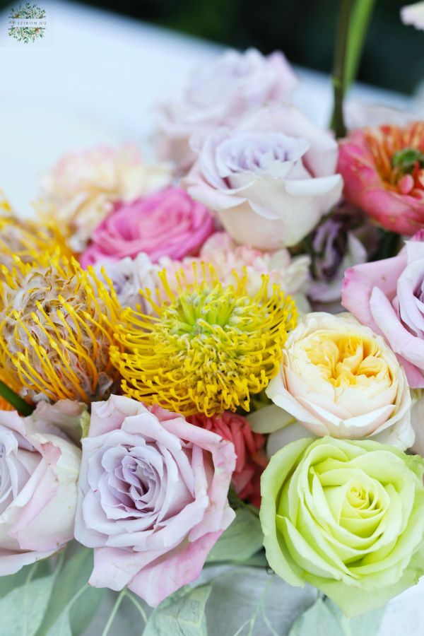 Modern floating table decoration for weddings and events (rose, English rose, leucospermum, carnation, yellow, orange, lavender, pink)