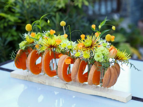 Modern wedding table decoration, event table decoration, autumn, made of pumpkins (chrysanthemum, sandersonia, lisianthus,  yellow, green)