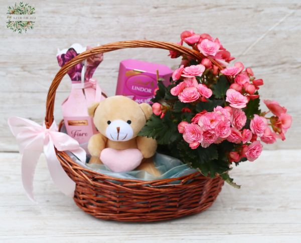 pink basket with teddy bear, chocolates and a flower
