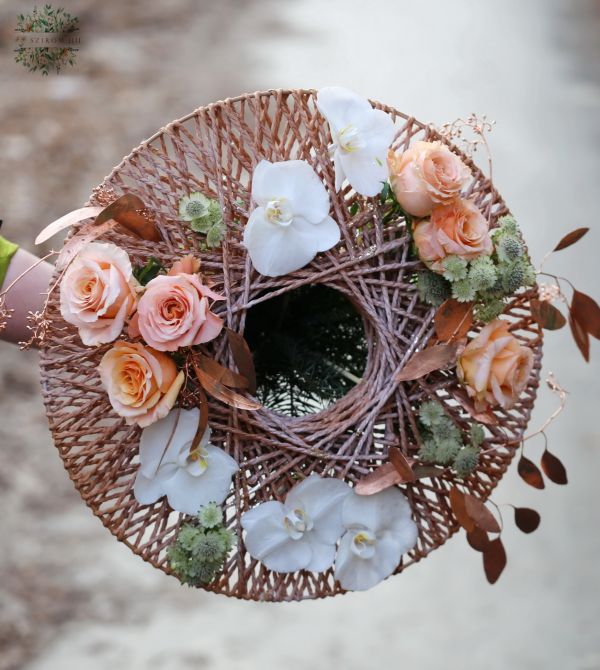 Bouquet in a rope bouquet holder with roses and phalaenopsis