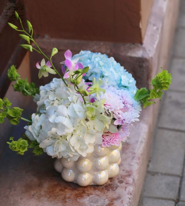 Pearlescent vase with hydrangea and orchid