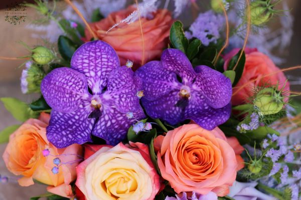 Romantic summer flower arrangement with roses, orchids