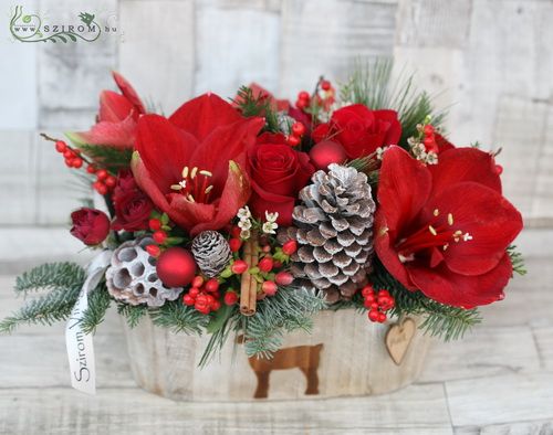 wooden pot with reindeer, with red flowers