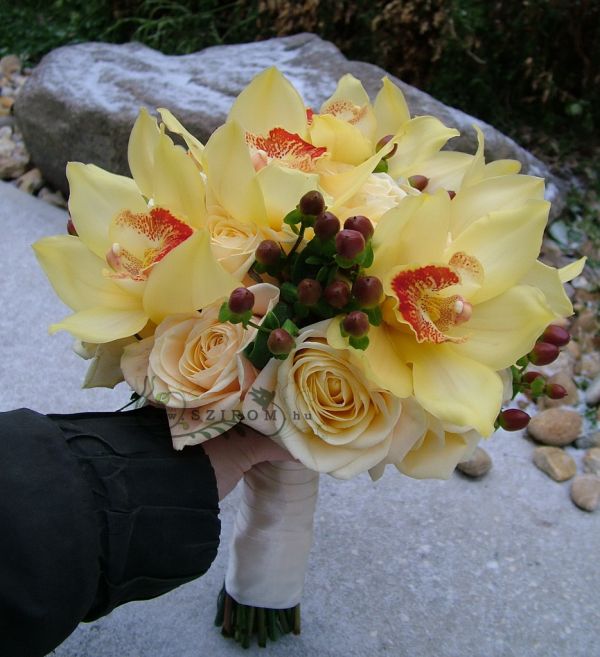 Bridal bouquet with yellow orchids, cream roses (hypericum,peach) 