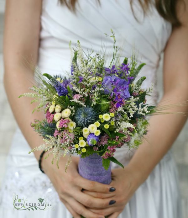 Bridal bouquet with meadow flowers (veronika, matricaria, eryngium, sedum, blue)