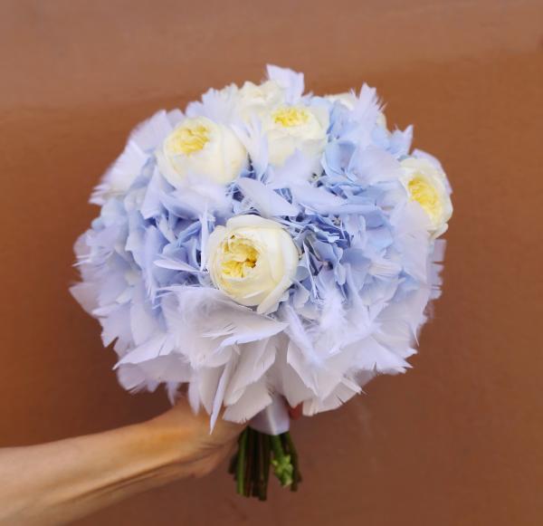 bridal bouquet with feathers made of English roses and hydrangeas