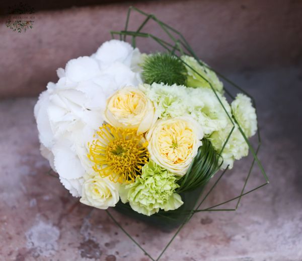 Modern glass cube with foamy summer cooling colored flowers