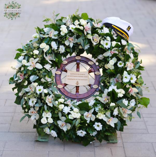 Large standing Greek-style wreath with spray roses, orchids, and chrysanthemums.
