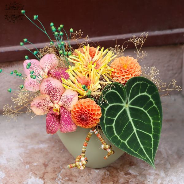 Autumn flower arrangement with dahlias, Vanda orchids, and a beautiful Anthurium clarinervium leaf.
