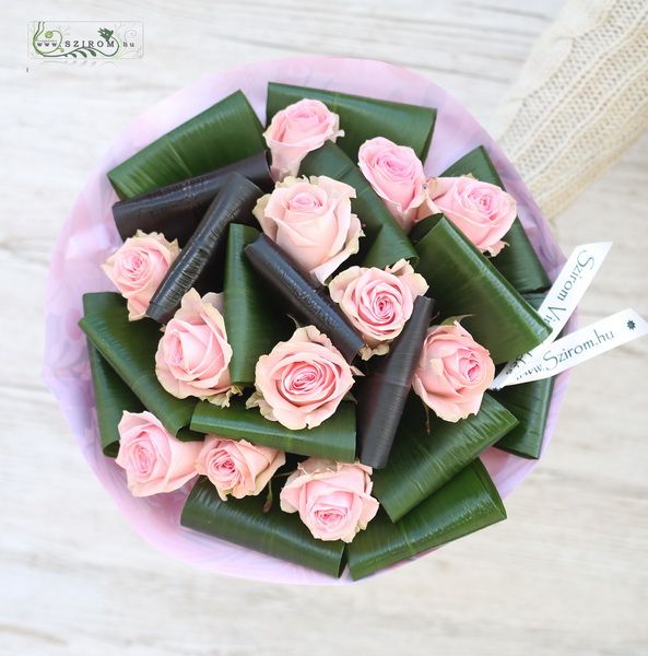 12 pink roses with aspidistra leaves