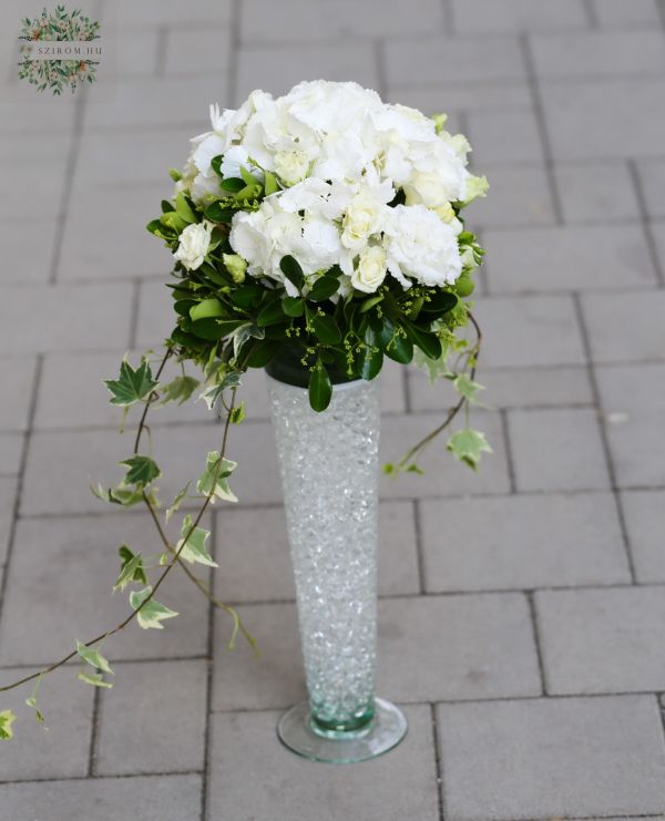 Glass vase with tall table decoration hydrangea (white, hydrangea, spray rose, lisianthus)