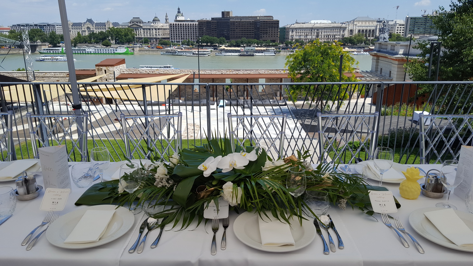 Virágküldés Budapest - Esküvői asztaldísz, Bazaar Eclectica Étterem Budapest (phalaenopsis orhidea, monstera, pálmalevél, fehér, zöld, arany)