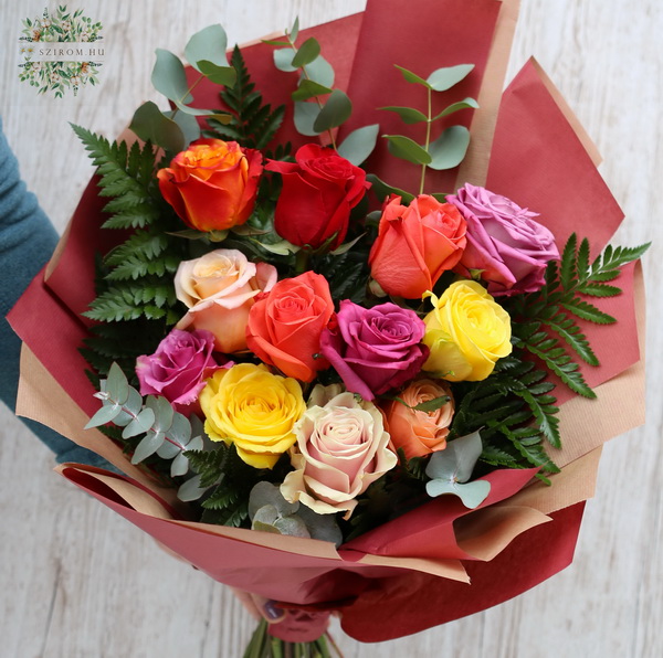 flower delivery Budapest - 12 colorful roses in craft paper with greenery