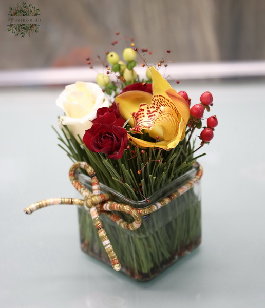 Blumenlieferung nach Budapest - Blumen zwischen Pinenadeln im Glasskubus