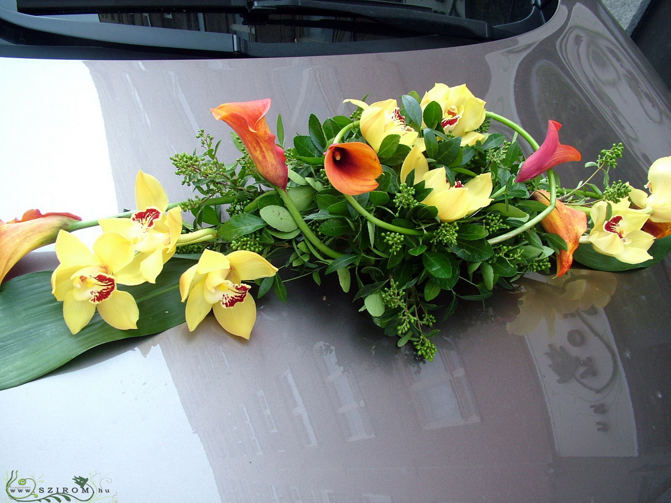 flower delivery Budapest - oval car flower arrangement with orchids and callas (yellow, orange)