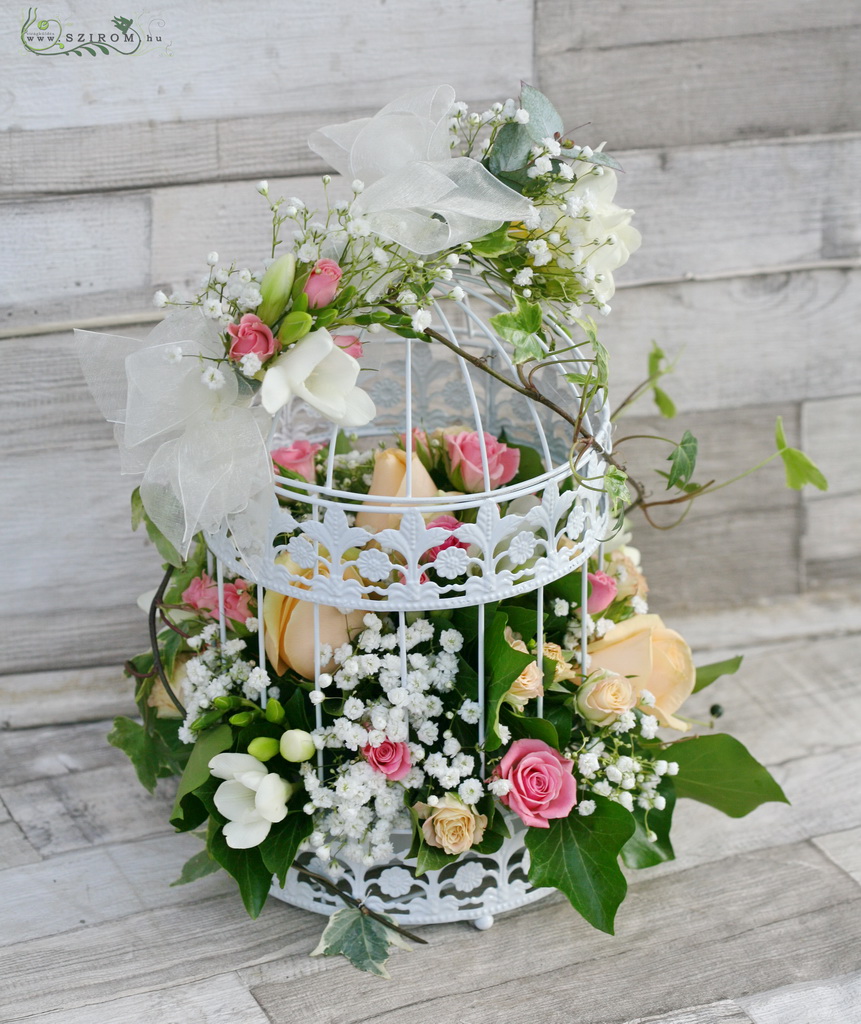 Virágküldés Budapest - Esküvői asztaldísz kalitka pasztell virágokkal (rózsaszín, barack, rózsa, rezgő, frézia)