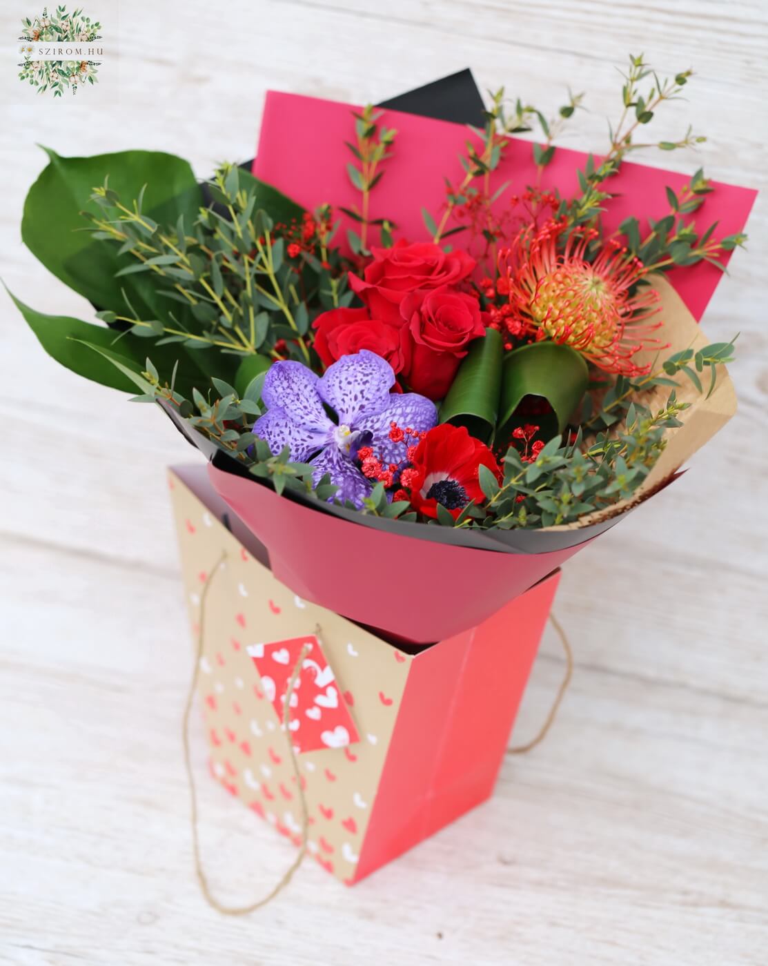 flower delivery Budapest - small red bouquet with purple orchid in a portable floral bag with handles